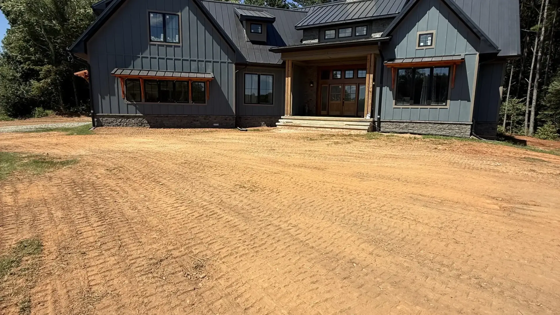 Newly graded residential lot in front of a home for turnkey site work